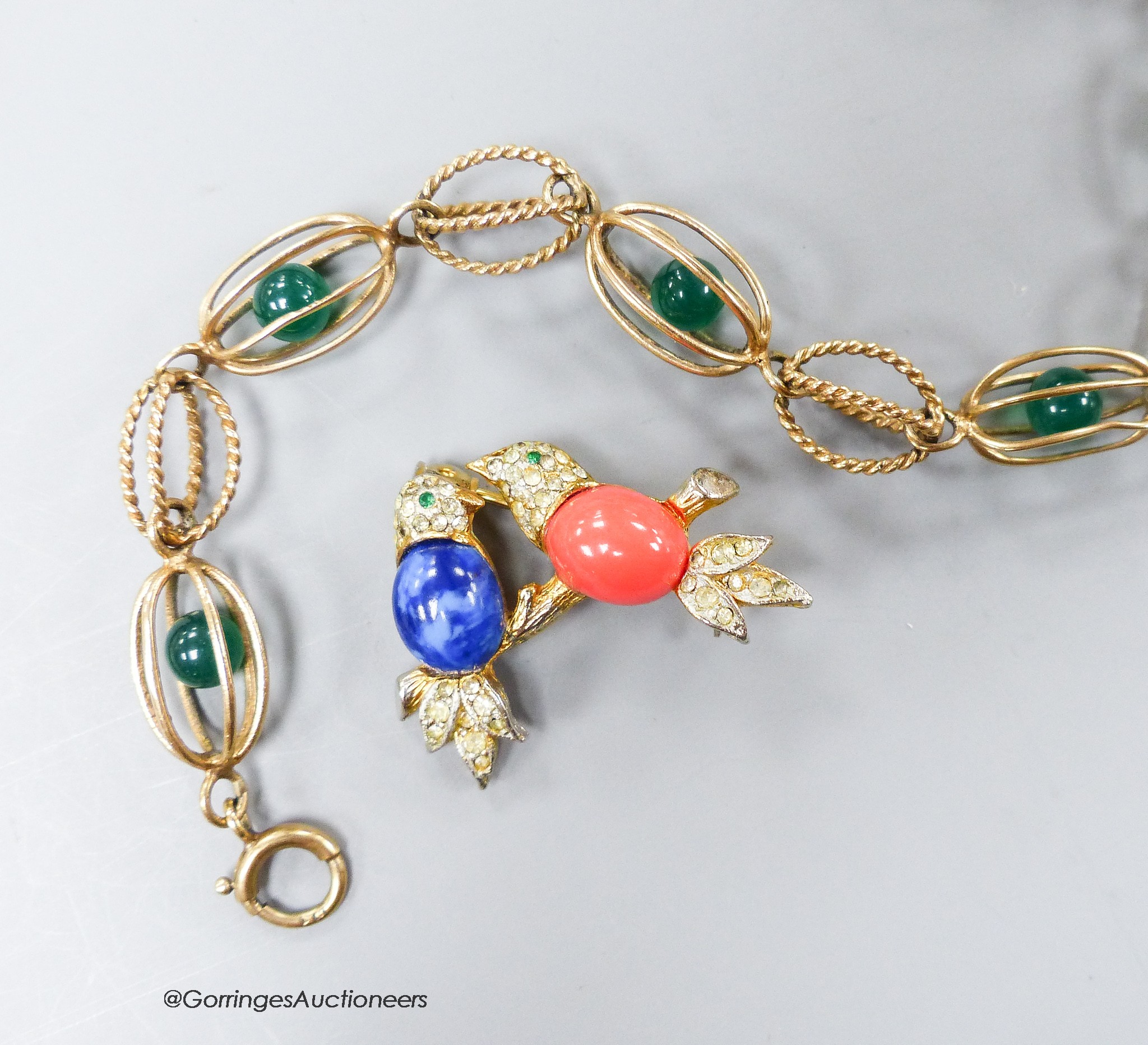 A yellow metal and caged chrysoprase bead bracelet, 18.5cm, gross 8 grams and a costume brooch.